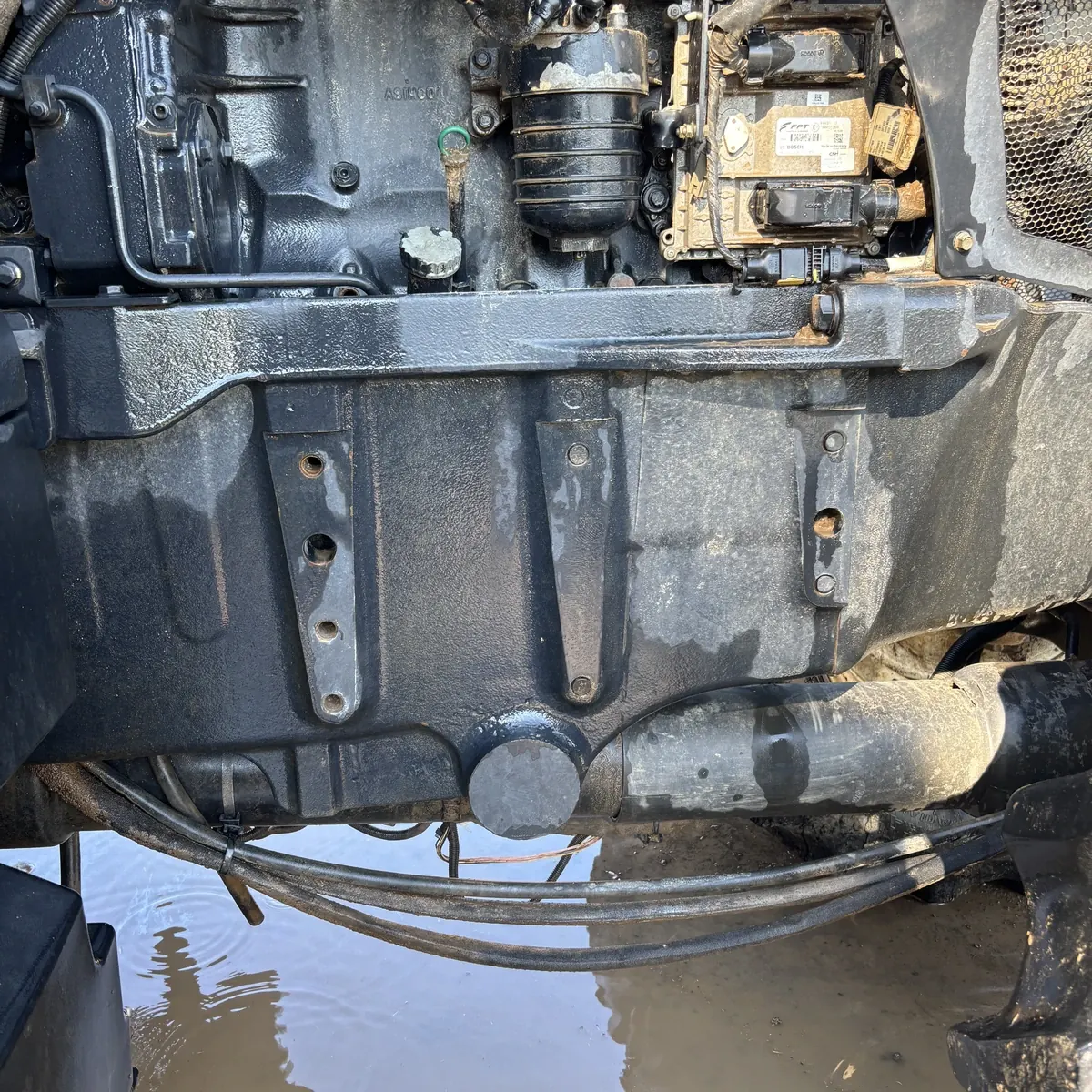 New Holland engine underside before cleaning