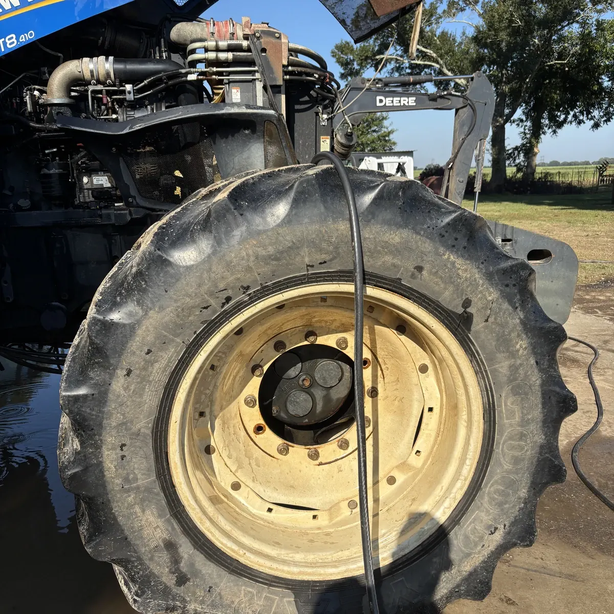New Holland tractor wheel before cleaning